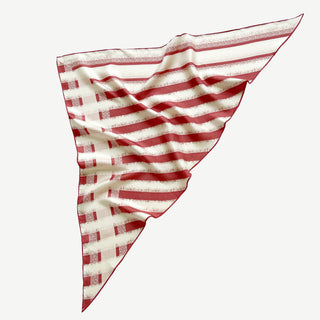 Triangle silk scarf with grapefruit pink and cream stripes, displaying luxurious sand-washed finish and hand-rolled edges with elegant draping.