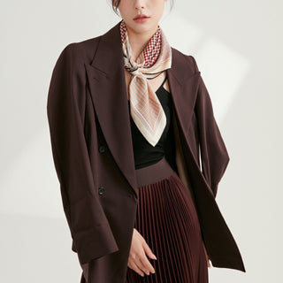 Silk houndstooth scarf in red, black and white styled with burgundy blazer and pleated skirt, showcasing elegant pattern and versatile styling