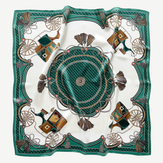 Luxurious square silk scarf with emerald green baroque design featuring ornate carriage wheels, tassels, and decorative chains on white background
