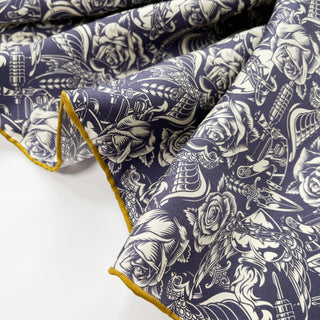 Luxurious ink blue silk scarf with white Gothic rose pattern and decorative elements, featuring elegant mustard yellow hand-rolled edges