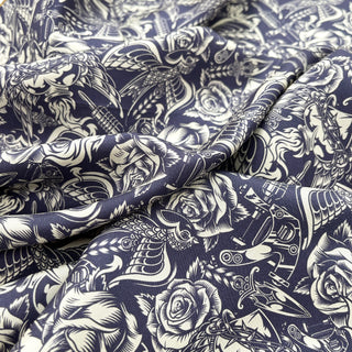 Ink blue silk scarf with intricate gothic rose pattern and ornate designs in white, draped to show luxurious texture and detailed artwork