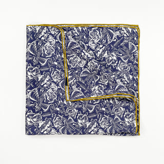 Square silk scarf with intricate white gothic rose pattern on ink blue background, finished with mustard yellow hand-rolled edges