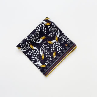 Amazon Toucan organic cotton-silk scarf in midnight black, folded neatly on a white background.