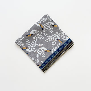 Amazon Toucan organic cotton-silk scarf in stone grey, folded neatly on a white background.