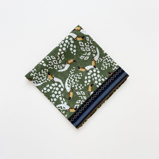 Amazon Toucan organic cotton-silk scarf in green, folded neatly on a white background.