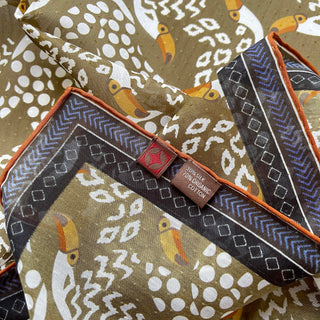 Organic cotton-silk scarf in mustard ochre with toucan print and understated jacquard, featuring contrast border