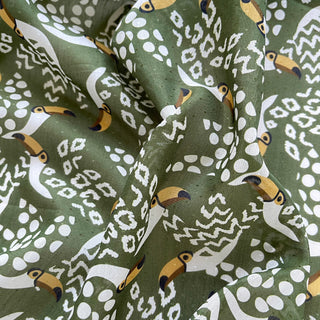 Organic cotton-silk scarf in green with toucan print and understated jacquard texture