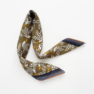 Organic cotton-silk scarf in mustard ochre with toucan print and understated jacquard, featuring contrast border and hand-rolled edges