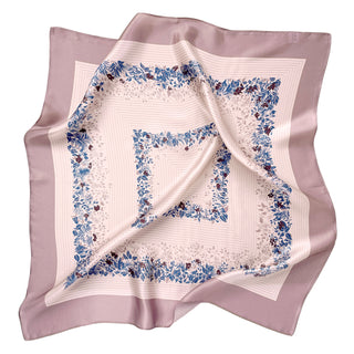 Square silk scarf with blush pink border and cream center featuring blue and burgundy leaf pattern. Elegant 65cm bandana displayed with gentle folds showing natural sheen.