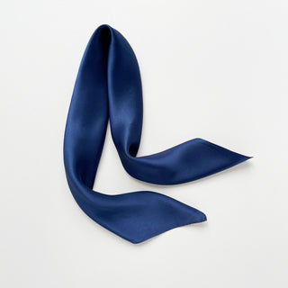 Navy blue silk satin scarf on a light gray background