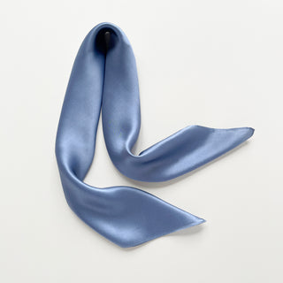 Sky blue silk satin scarf on a light gray background