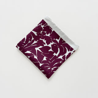 Folded silk scarf in burgundy floral print with ice white border, 65cm square.