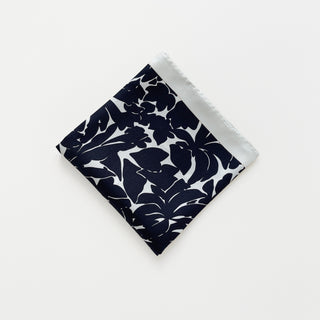 Folded silk scarf in black floral print with ice white border, 65cm square.
