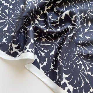 Close-up of black floral silk scarf, 65cm square with hand-rolled ice white border.
