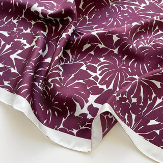 Close-up of burgundy floral silk scarf, 65cm square with hand-rolled ice white border.
