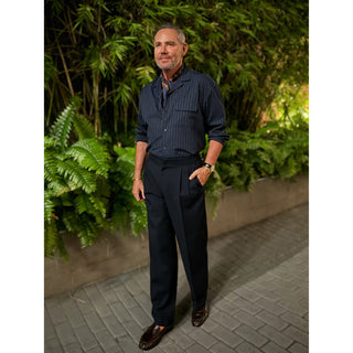 Man wearing a navy paisley silk square scarf by LuluLane in striped navy shirt and navy trousers showcasing a sharp and refined look.