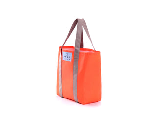 Bright orange recycled large tote bag with gray handles and decorative trim, featuring a small label with Chinese button design detail