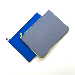 Minimalist recycled laptop sleeves in vibrant blue and gray with yellow trim, featuring YKK zippers and traditional Chinese button detail.