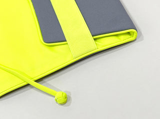 Eco-friendly recycled notebook cover in neon yellow and gray, featuring elastic strap closure and compartment for tablets or notebooks
