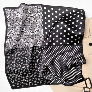 Black and white silk scarf featuring four distinct patterns: paisley, large polka dots, small polka dots, and traditional bandana print