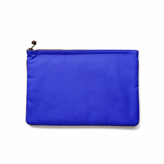 Vibrant blue minimalist laptop sleeve with YKK zipper and decorative button, made from recycled materials for 13-14 inch MacBooks
