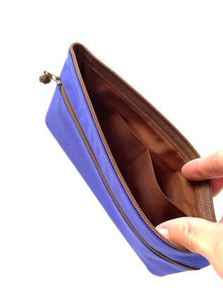 Open blue recycled RPET wallet with brown interior lining, showing compartment design with piping detail and zipper closure
