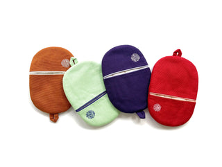 Four oval linen oven mitts in different colors - brown, mint green, purple, and red - featuring decorative embroidery and hanging loops