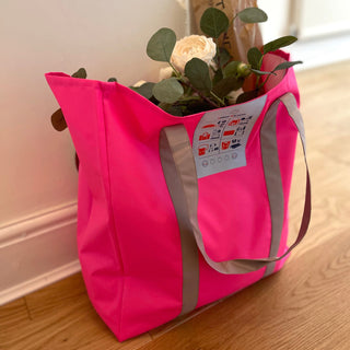 Bright pink recycled large tote bag with gray handles containing fresh flowers and greenery, showcasing its spacious design and eco-friendly RPET material