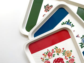 Three vintage Chinese character melamine trays in forest green, blue, and red with floral decorative patterns and traditional Chinese motifs.