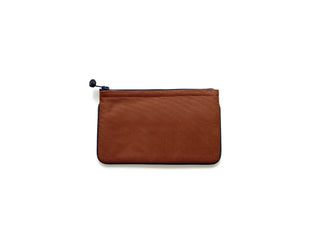 Handmade recycled zipper wallet in terracotta brown with navy trim and zipper, featuring clean piping edges and traditional Chinese button pull