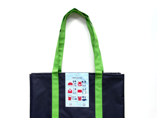 Recycled large tote bag in navy blue with bright green handles, featuring an 'Urban Walkers' label with colorful icons showing various uses for the bag.