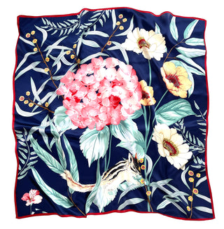 Luxury silk scarf with navy blue background featuring pink hydrangea blooms, cream flowers, mint leaves, and small chipmunk design, bordered with red trim