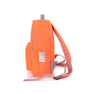 Bright orange recycled RPET backpack with gray straps, side view showing water bottle pocket and brand tag, featuring 1mm piping trim detail