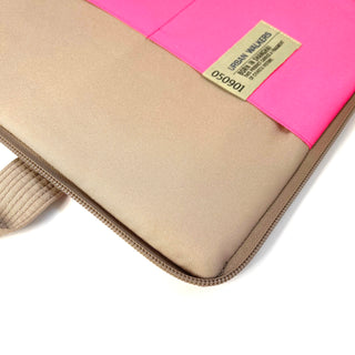 Recycled laptop briefcase featuring beige fabric with vibrant pink accent strip, zippered closure, and Urban Walkers brand tag, showcasing eco-friendly RPET material